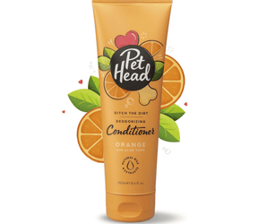White background with an orange bottle of Pet Head Ditch the Dirt conditioner for dogs. On the bottle is illustrated coconuts, leaves and a dog bone with text 'Ditch the Dirt, Deodorising, Conditioner, Orange with Aloe Vera'.