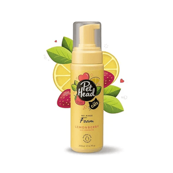 White background with a yellow pump bottle of Pet Head No-Rinse Foam for cats. On the bottle is illustrated lemons, leaves and strawberries with text 'No-Rinse Foam, Lemonberry with Lemon oil.'.