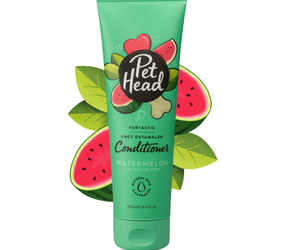 White background with a green bottle of Pet Head Furtastic conditioner for Dogs. On the bottle is illustrated watermelons, leaves and a dog bone with text 'Furtastic, Knot Detangler Conditioner, Watermelon with Shea Butter'.
