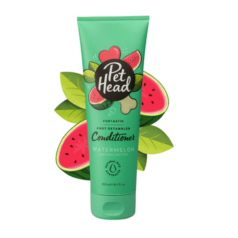 White background with a green bottle of Pet Head Furtastic conditioner for Dogs. On the bottle is illustrated watermelons, leaves and a dog bone with text 'Furtastic, Knot Detangler Conditioner, Watermelon with Shea Butter'.