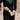 Bathroom with a woman dressed in black pouring a green bottle of Pet Head Mucky Pup shampoo for Puppies into her hand.