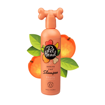 White background with a peach coloured bottle of Pet Head Quick Fix shampoo for Dogs. On the bottle is illustrated oranges, leaves and a dog bone with text 'Quick Fix, 2 in 1 Shampoo, Peach with Argan Oil'.