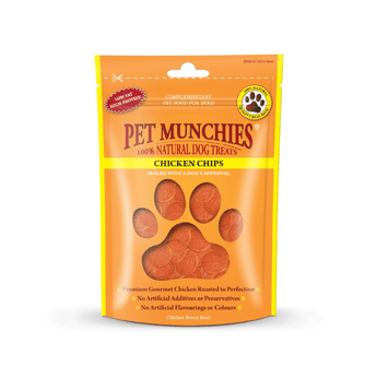 A stand-up pouch of Pet Munchies 100% Natural Dog Treats Chicken Chips, featuring a bright orange and yellow design with a paw print window showing the round chicken chip treats inside.