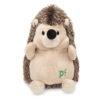 Front facing hedgehog dog toy with a cream belly, face, legs and ears and brown spikey effect soft fabric for spines. Stitch detail in green of 'PF' on belly. Sat on a white background.