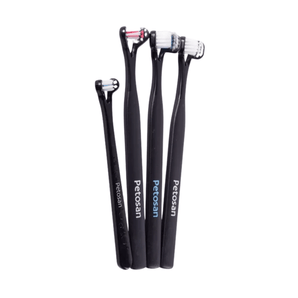 White background with a four black doubled headed toothbrushes for dogs pictured.