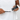 Partial view of a person, wearing a white t-shirt putting Petosan Toothpaste for Dogs onto a black toothbrush.