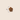A small brown flower-shaped treat or kibble piece centred on a light beige background, with a vertical measurement marker labelled 2cm beside it.