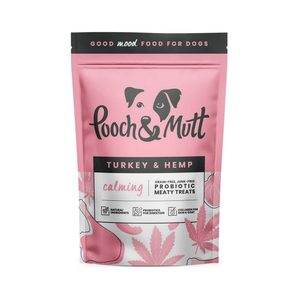 White background with a pink packet of Pooch & Mutt dog treats. The text on the packet states 'Turkey & Hemp, Calming, Grain-free, Junk-free, Probiotic Meaty Treats.'