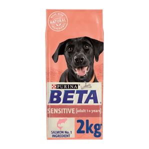 White background with a pink bag of Purina Beta Sensitive Adult Dog Food. Pictured on the bag is a black Labrador dog, text on the bag reads 'Purina Beta, Sensitive, Adult (1+ years) Salmon No.1 Ingredient.'
