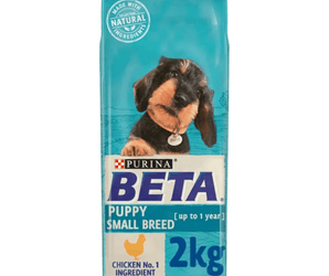 White background with a blue bag of Purina Beta Small Breed Puppy Food. Pictured on the bag is a dachshund puppy text on the bag reads 'Purina Beta, Puppy Small Breed (up to 1 year) Chicken No.1 Ingredient.'