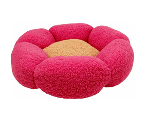 White background with a pink flower shaped cat bed with a yellow centre.