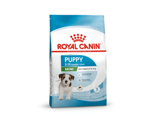White background with a blue bag of Royal Canin Mini Puppy. Pictured on the bag is a terrier puppy , text on the bag states '2 - 10 months' and 'Mini, Adult Weight upto 10kg'.