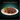 Black background with a teal bowl of Sheba Fine and Fresh wet food in gravy pictured.