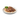 Plated dish of Sheba with sauce and garnish on a white background