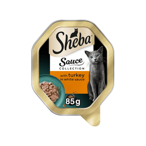 White background with a tray of Sheba Sauce Collection with Turkey in white sauce, pictured on the front is a British blue cat.