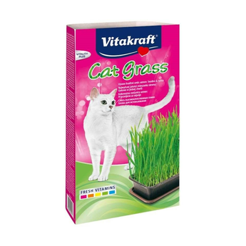 White background with a pink and green box of Vitakraft Cat Grass. On the box a white cat is pictured next to a tray of cat grass.