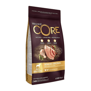 White background with a picture of a bag of Wellness CORE Original Dog Food. On the bag is pictures of chicken leg, turkey fillet, blueberries and a beet. The text on the bag 'Wellness CORE, Natural, Grain Free, Protein-Rich' and 'All breeds, Senior Original, Turkey with Chicken Recipe'.