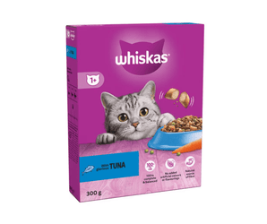 White background with a purple box of Whiskas Tuna dry food, on the box is silver tabby cat in front of a bowl on food. Text on the box reads 'Whiskas, 1+ years, with glorious tuna, 300g'.