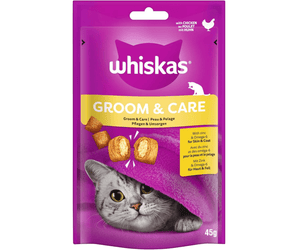 White background with a purple packet of Whiskas Groom & Care Treats, on the packet is silver tabby cat's face under a purple blanket. Text on the pack reads 'Whiskas Groom & Care, with Zinc & Omega-6 for Skin & Coat.'
