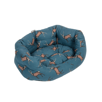 Bolster-type blue dog bed with illustrated stags pictured on a white background.