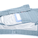 White background with a geometric blue bodysuits for cats pictured, showing the inside pocket with a medical wound pad inside. 