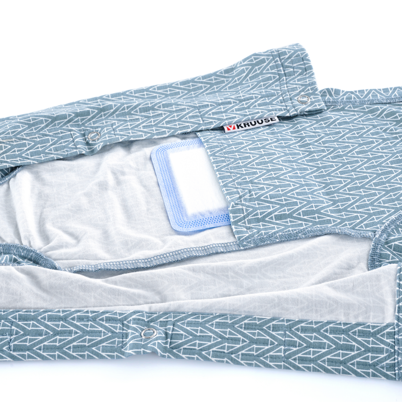 White background with a geometric blue bodysuits for cats pictured, showing the inside pocket with a medical wound pad inside. 