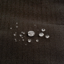 Close up of a Bolster-type black dog bed with water droplets pictured on the waterproof surface. 