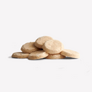 White background with a pile of disc shaped dog treats. 