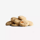 White background with a pile of disc shaped dog treats. 