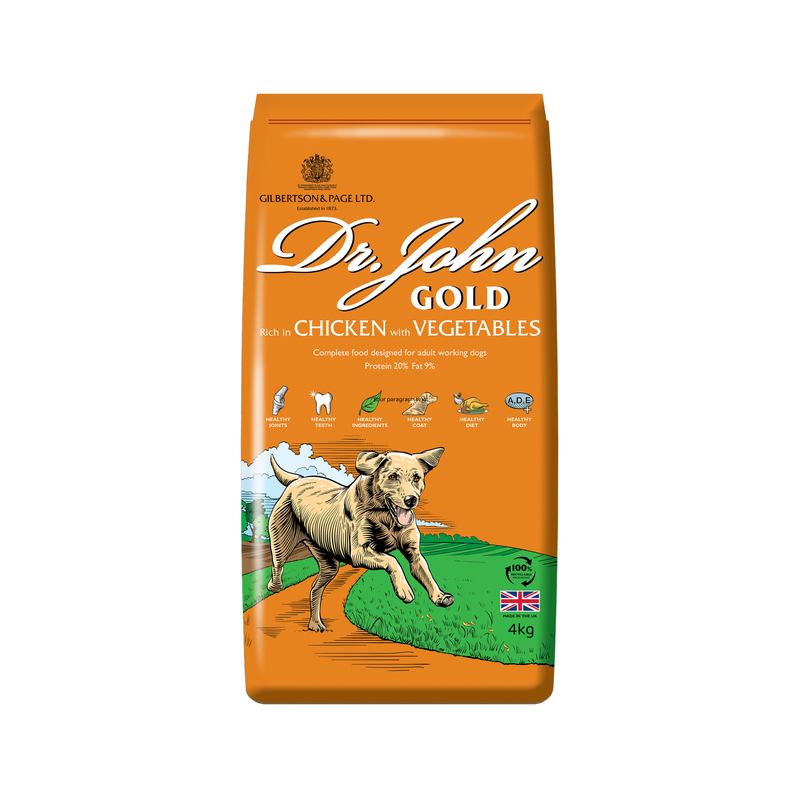 White background with a orange bag of Dr.John Gold Chicken and Vegetables dry food. Pictured on the bag is an illustrated Labrador dog in a farm field. 