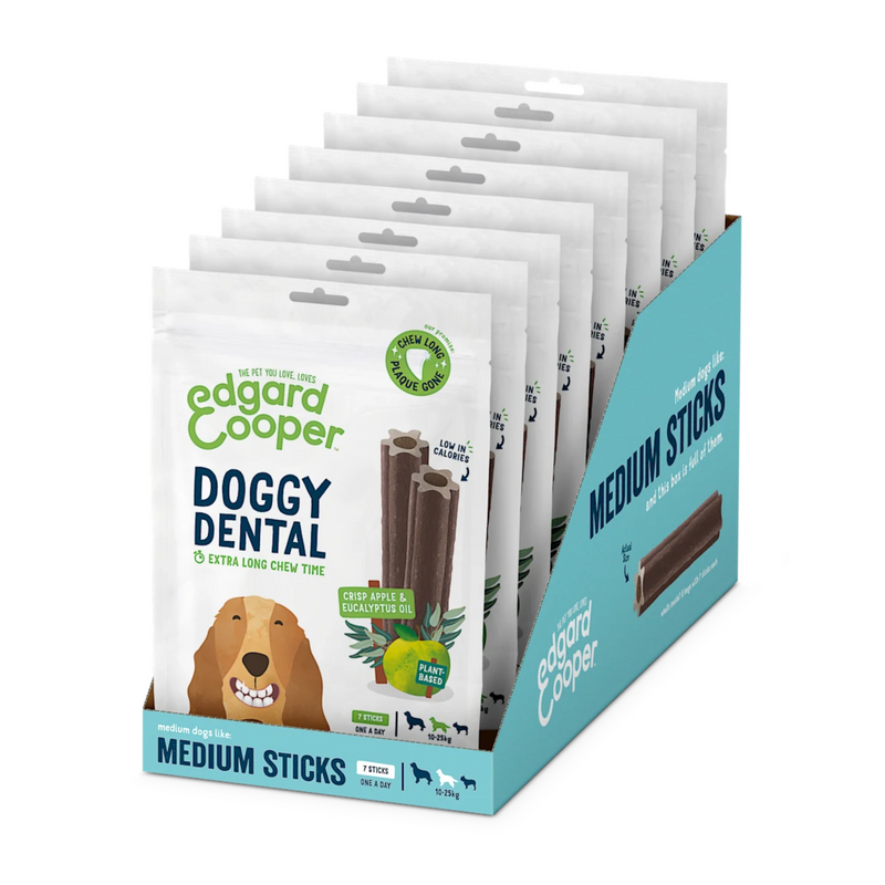 White background with a box of 8 packets of Edgard & Cooper Doggy Dental Sticks pictured. On the packet is an illustrated Spaniel with a teethy grin. Text on the pack reads, 'Edgard & Cooper, Doggy Dental, Extra Long Chew Time' with a picture of a stick treat to the right, text next to it reads 'Crisp Apple & Eucalyptus Oil. Plant based.'  