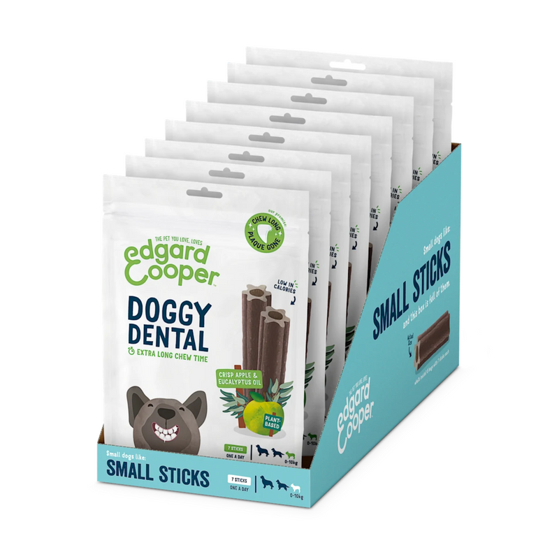 White background with a box containing 8 packets of Edgard & Cooper Doggy Dental Sticks pictured. On the packet is an illustrated French Bulldog with a teethy grin. Text on the pack reads, 'Edgard & Cooper, Doggy Dental, Extra Long Chew Time' with a picture of a stick treat to the right, text next to it reads 'Crisp Apple & Eucalyptus Oil. Plant based.'  