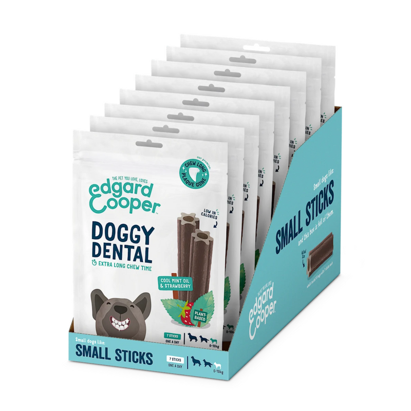White background with a box of 8 packets of Edgard & Cooper Doggy Dental Sticks pictured. On the packet is an illustrated French Bulldog with a teethy grin. Text on the pack reads, 'Edgard & Cooper, Doggy Dental, Extra Long Chew Time' with a picture of a stick treat to the right, text next to it reads 'Cool Mint Oil & Strawberry. Plant based.'  