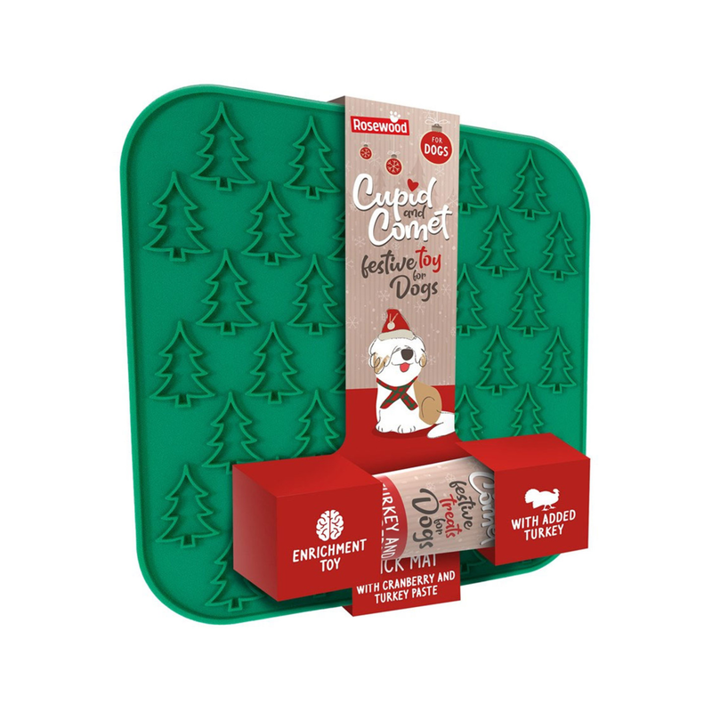 White background with a green lickmat with Christmas trees motif with a cardboard sleeve around it with a tube of Turkey and Cranberry paste attached to it. 