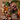 A styled flat-lay of raw ingredients arranged on a wooden cutting board and table, including chunks of beef and wild boar meat, root vegetables, apples, carrots, herbs, and small bowls of powder and liquid. Text overlays read 'root veg & apple' and '75% high quality beef & wild boar'.
