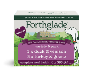 A box of Forthglade Natural Complete Meal Adult wet dog food, variety 6 pack, containing duck, venison, turkey, and goose. The packaging features a white background with green and purple banners, a green landscape illustration, and a white dog.