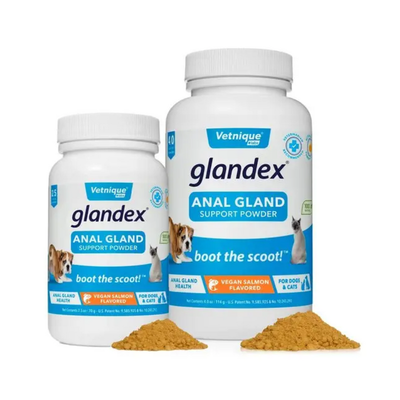 White background with two blue and white tubs of Glandex Anal Gland Support Powder, one larger than the other.  On the tubs is a picture of a bull dog with its bottom pointed forwards. Additional text states 'Boot the scoot!' and 'Anal gland health, Vegan Salmon Flavoured, for cats and dogs.' In the foreground is a small pile of the powder in front of each bottle.