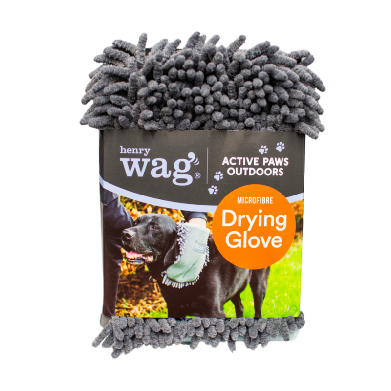 Grey microfibre Microfibre Pet Drying Glove in a cardboard sleeve with text 'Henry Wag, Active Paws Outdoors, Microfibre Drying Glove' with a picture of a black Labrador being wiped down with the grooming glove. Pictured on a white background. 
