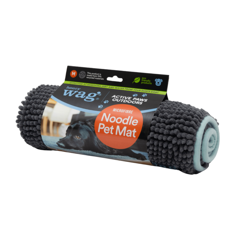 Grey microfibre noodle pet mat rolled up in a cardboard sleeve with text 'Henry Wag, Active Paws Outdoors, Microfibre Noodle Pet Mat' with a picture of a black cocker Spaniel lying on a mat. Pictured on a white background. 