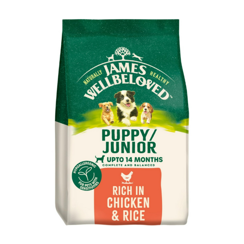 White background with a bag of James Wellbeloved Chicken & Rice Puppy/Junior Food. Packaging is green and cream with 3 puppies pictured, with text 'Puppy/Junior ,Upto 14 months, Rich in Chicken & Rice'. 
