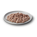 White background with a white bowl pictured filled with wet kitten food.