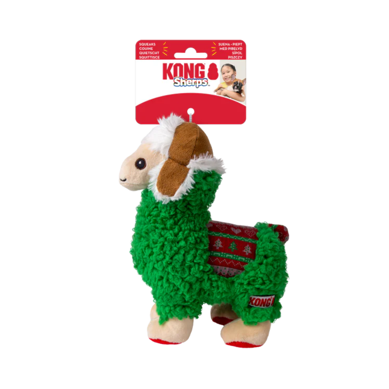 Green fabric Llama Dog Toy with a brown winter hat and festive fabric saddle attached to a cardboard backing, pictured on a white background. 