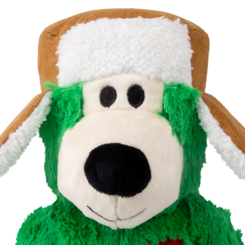 Close up of green fabric Bear Dog Toy with a brown winter hat pictured on a white background. 