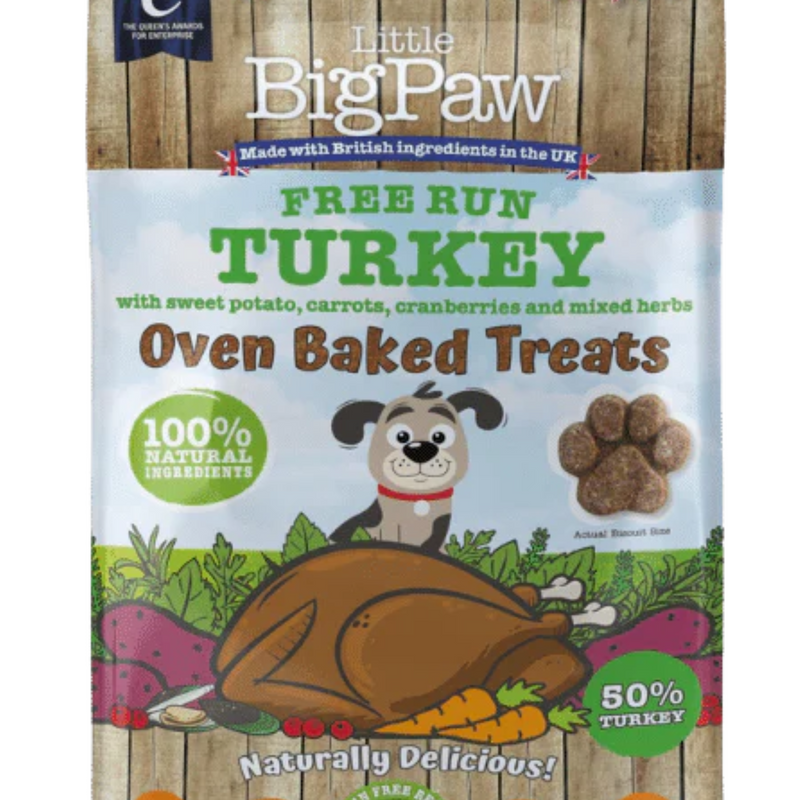 White background with a close up of a packet of Little BigPaw 'Free Run Turkey with sweet potato, carrots, cranberries and mixed herbs' dog treats. Pictured on the packet is an illustration of a grey dog with a cooked turkey and vegetables in the foreground. Text on the bag says 'Oven Baked Treats, 100% natural ingredients, Naturally delicious! 50% turkey'. 