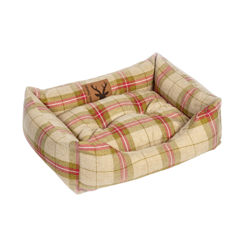 Bolster red and green checked dog bed pictured on a white background. 