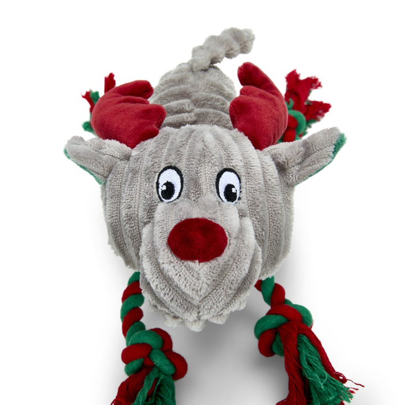 Close up of face of a grey reindeer dog toy with green and red twisted rope for legs and red fabric antlers on a white background. 