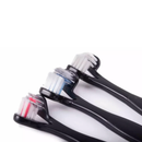 White background with a close up of three black doubled headed toothbrushes for dogs pictured. 