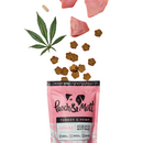White background with a pink packet of Pooch & Mutt dog treats, with treats pouring out, with a hemp leaf and chunks of turkey. The text on the packet states 'Turkey & Hemp, Calming, Grain-free, Junk-free, Probiotic Meaty Treats.'