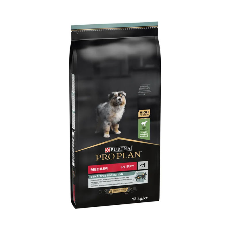 White background with a black bag of Purina Pro Plan Medium Puppy Sensitive Digestion. Pictured on the bag is an collie puppy. 