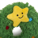 White background with a close up view of a plush dog toy Christmas wreath with a plush star with stitched eyes and smile. 